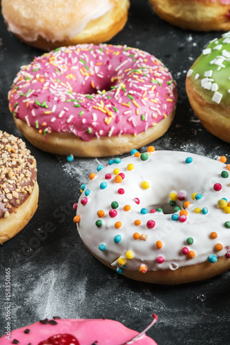 Donuts in a glaze assorted on a black background