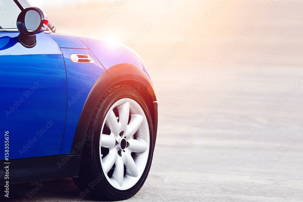 Cropped image of mini blue car in the sun light