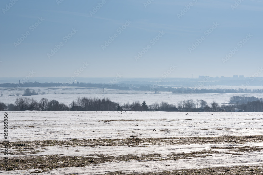 Fields covered with snow in spring