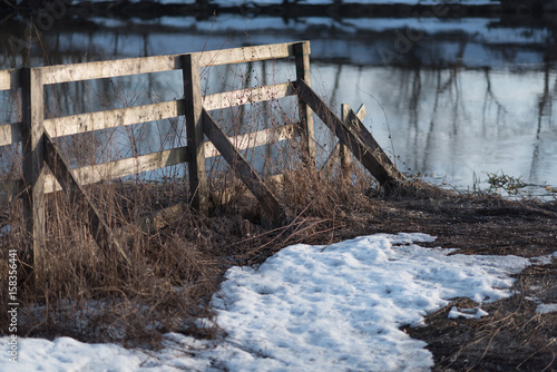 wooden fence near the river under the sunset