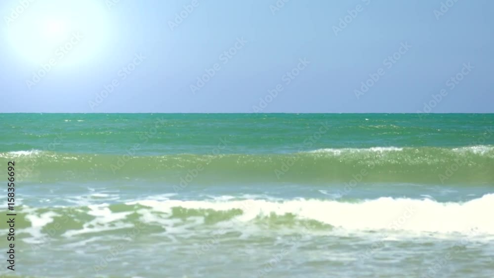 White Crests of Waves Crashing Against a Flat Sandy Beach White Crests of Waves Crashing Against a Flat Sandy Beach