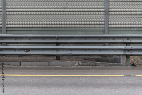 Wallpaper Mural Gray metal sheet fence with concrete sidewalk and asphalt road Torontodigital.ca