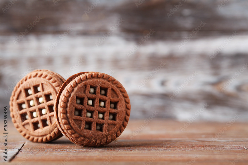 Chocolate cookies with cream on brown wooden table Chocolate cookies with cream on brown wooden table