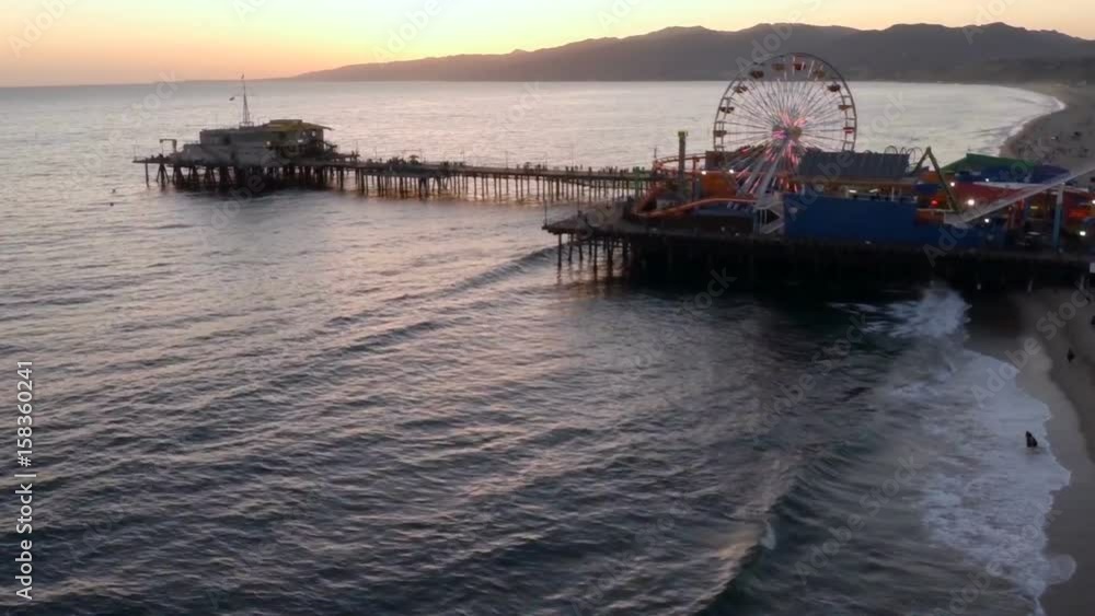 Aerial view of Santa Monica Pier with ferris wheel during sunset Aerial view of Santa Monica Pier with ferris wheel during sunset