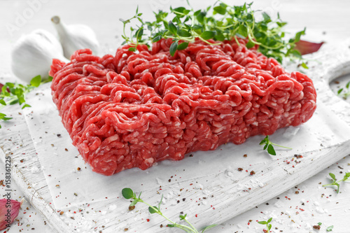 Konstfotografi Fresh Raw Beef Minced Meat with salt, pepper, chilli and fresh thyme on white board