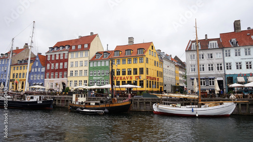 COPENHAGEN, DENMARK - MAY 31, 2017: The Nyhavn canal. Nyhavn is waterfront, canal and entertainment district in Copenhagen. It is lined by brightly coloured bars, cafes and restaurants, Denmark