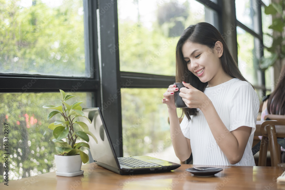 Beautiful business girl working with tablet , smartphone and drinking coffee in coffee shop Beautiful business girl working with tablet , smartphone and drinking coffee in coffee shop