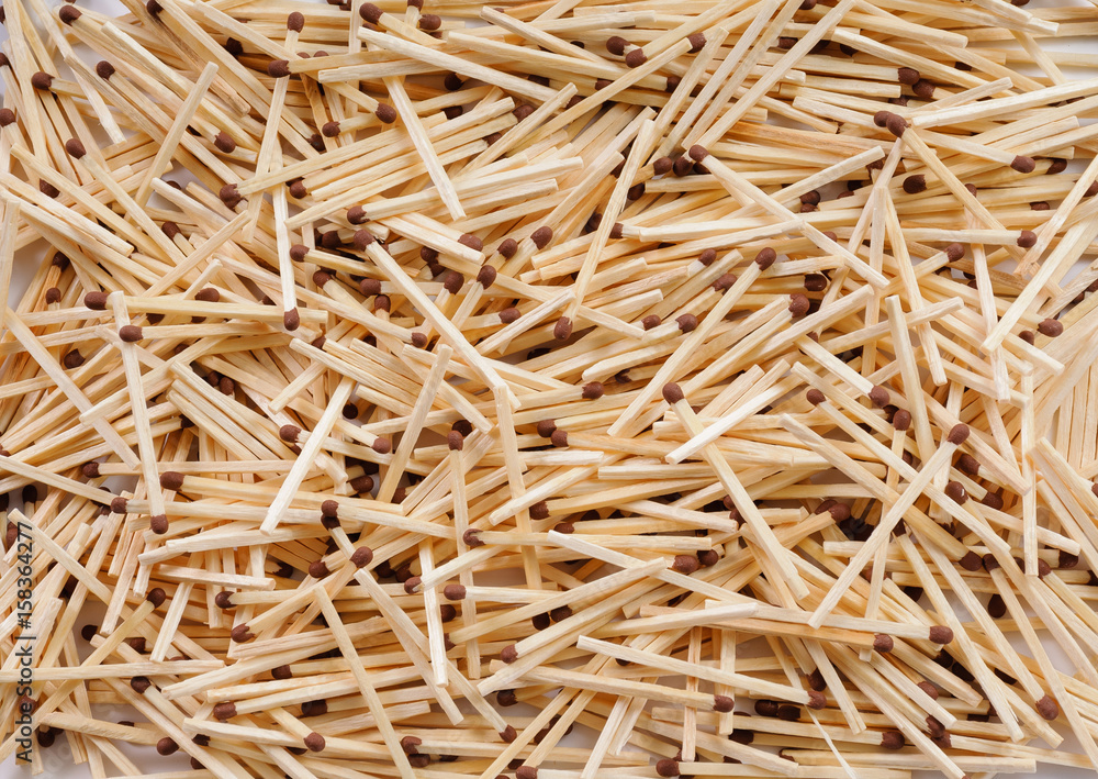 Many matches with brown match heads scattering on flat surface Many matches with brown match heads scattering on flat surface