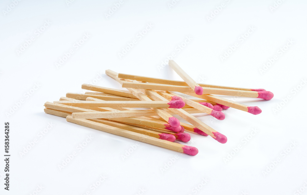 Pile of big matches with rose match head on white background Pile of big matches with rose match head on white background