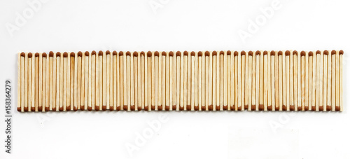 One row of many matches on white background view from above © ktv144