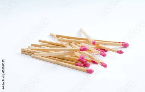 Pile of big matches with rose match head on white background