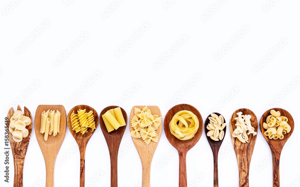 Italian foods concept and menu design. Various kind of Pasta Farfalle, Pasta A Riso, Orecchiette Pugliesi, Gnocco Sardo and Farfalle in wooden spoons isolate on white background with flat lay. Italian foods concept and menu design. Various kind of Pasta Farfalle, Pasta A Riso, Orecchiette Pugliesi, Gnocco Sardo and Farfalle in wooden spoons isolate on white background with flat lay.