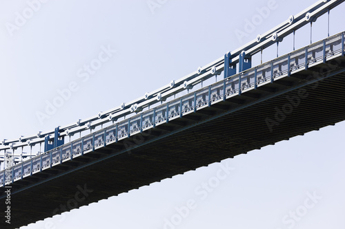 View of the steel decking & steel chains from the centre section of the Menai Suspension bridge, Isle of Anglesey, North Wales