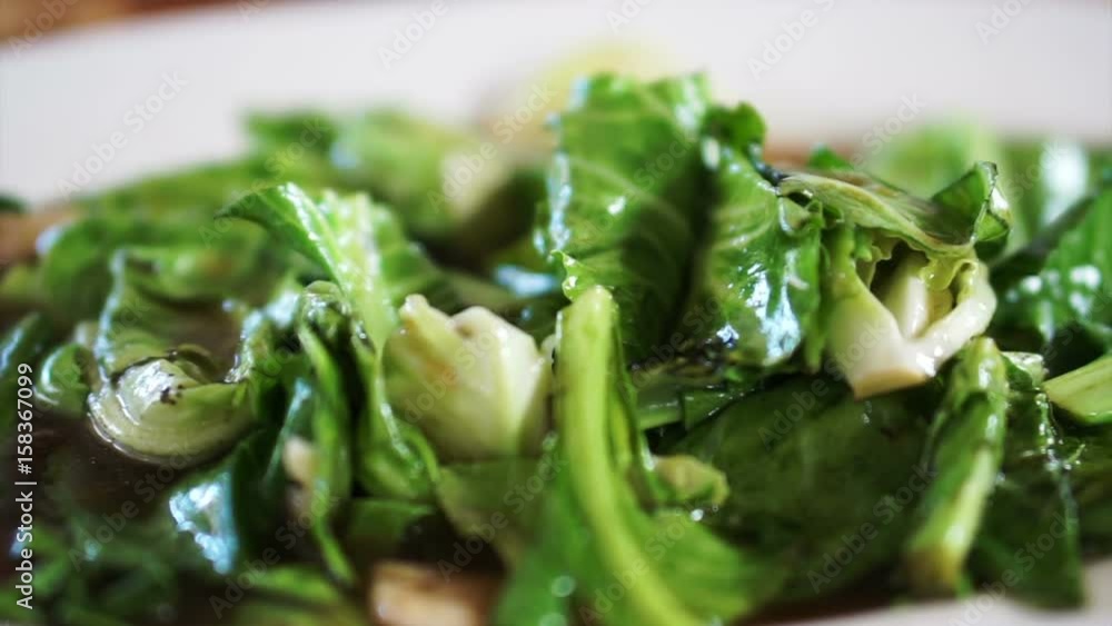 Bok choy or Chinese broccoli green vegetable stir fry with sauce in Thai Chinese restaurant Bok choy or Chinese broccoli green vegetable stir fry with sauce in Thai Chinese restaurant