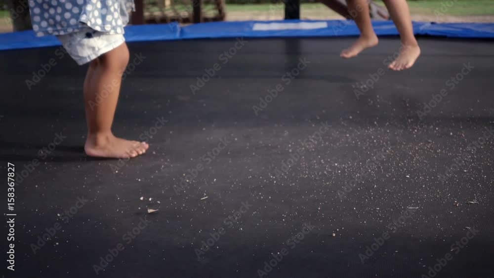 Little child jumping on trampoline in playground Little child jumping on trampoline in playground