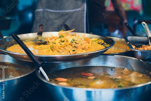 Street food in a wok and pan. Street food in a wok and pan