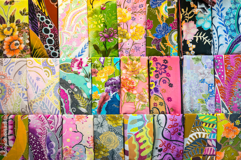 Various design of batik painting hanging in craft shop in Kuala
