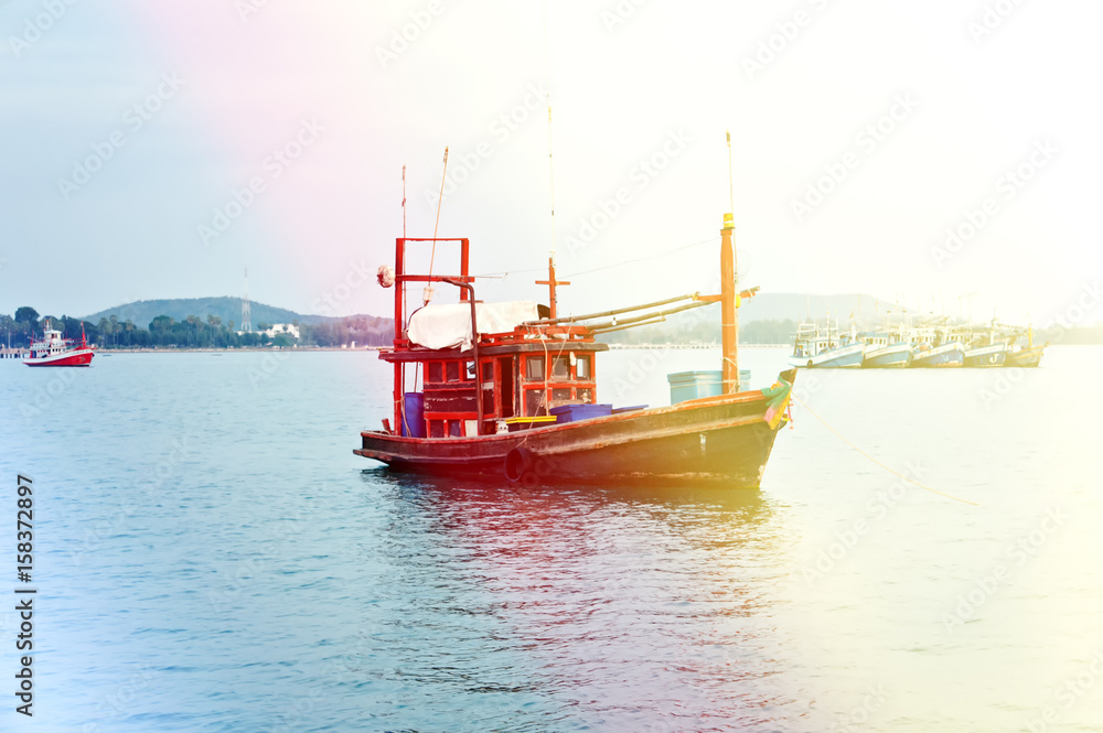 Fototapeta premium Fishing on an old boat at sunset