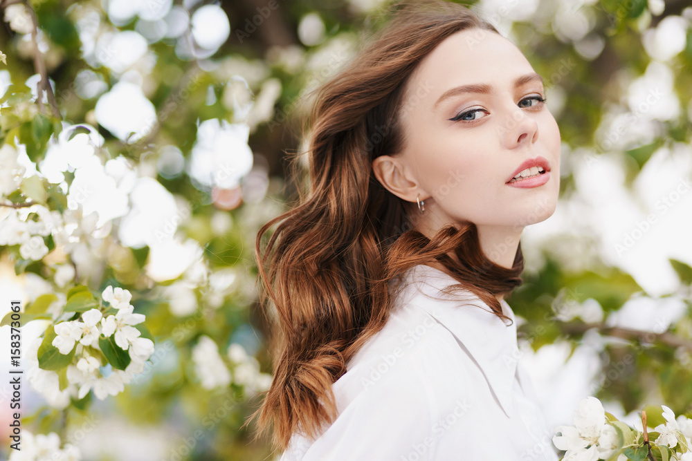 Portrait of young beautiful woman on green flower background in summer Portrait of young beautiful woman on green flower background in summer