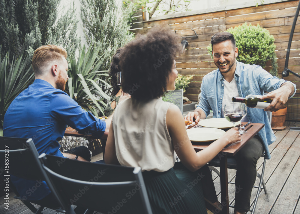 Cheerful young people have lunch in the courtyard and have a fun Cheerful young people have lunch in the courtyard and have a fun