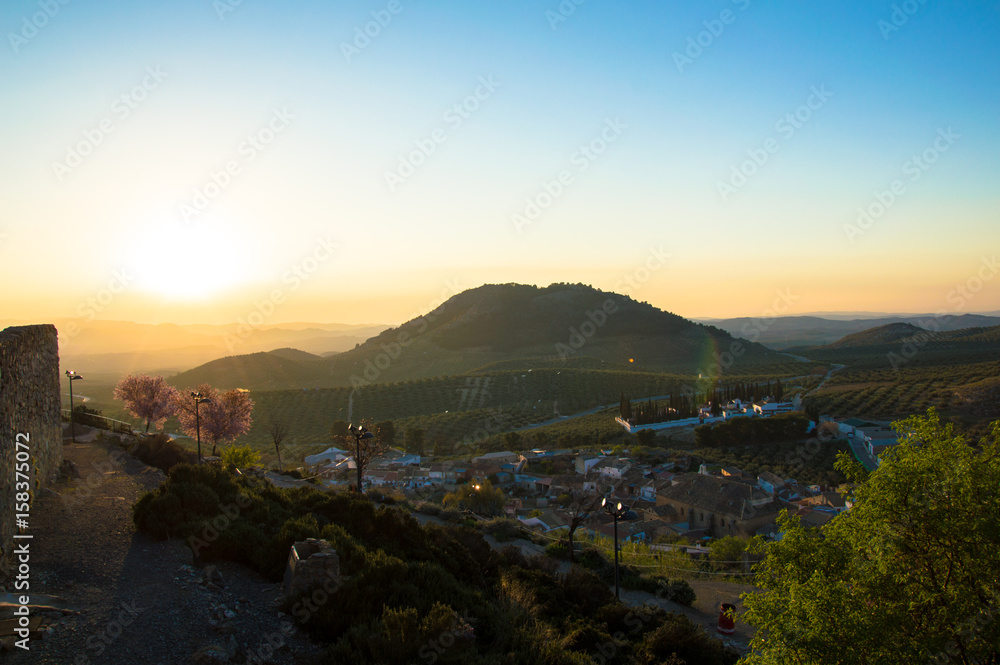 Panoramic and idyllic Andalusian landscape, mountain village Alcaudete at sunset