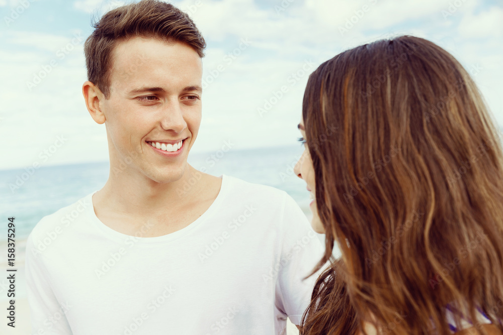Romantic young couple standing on the beach Romantic young couple standing on the beach
