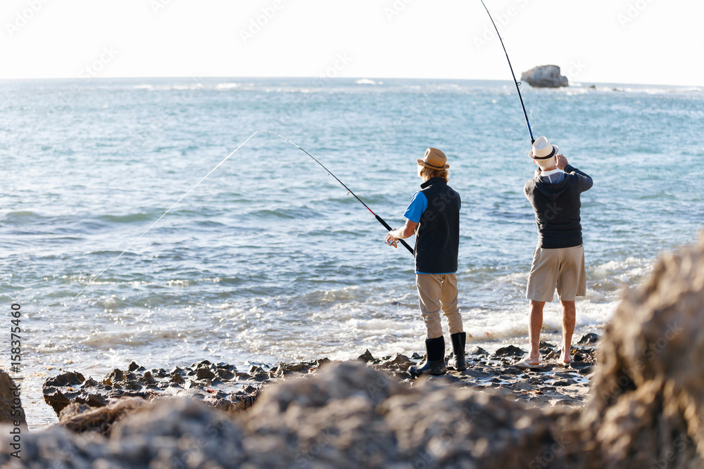 Senior man fishing with his grandson Senior man fishing with his grandson
