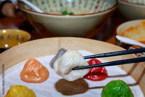 Colorful dim sum in bamboo steamer, chinese cuisine photo