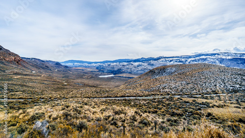 Thompson River flowing through semi desert landscape of the Thompson River Valley viewed from Juniper Beach Provincial Park betweeen Kamloops and Cache Creek, British Columbia, on a cold winter day © hpbfotos
