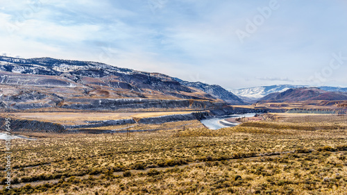 Thompson River flowing through semi desert landscape of the Thompson River Valley viewed from Juniper Beach Provincial Park betweeen Kamloops and Cache Creek, British Columbia, on a cold winter day