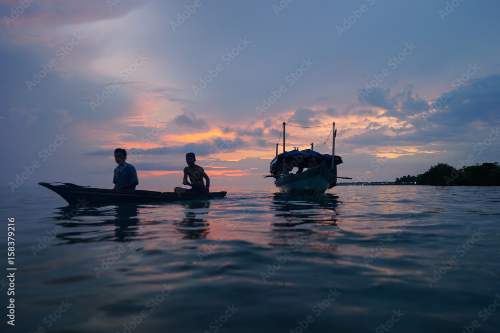 View of Sea Gypsy village (Bajau Laut) during sunrise at Mabul island, Sabah, Malaysia. The Bajau Laut are the sea gypsies who live in the open sea.