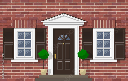 brick house facade with front door windows and plants