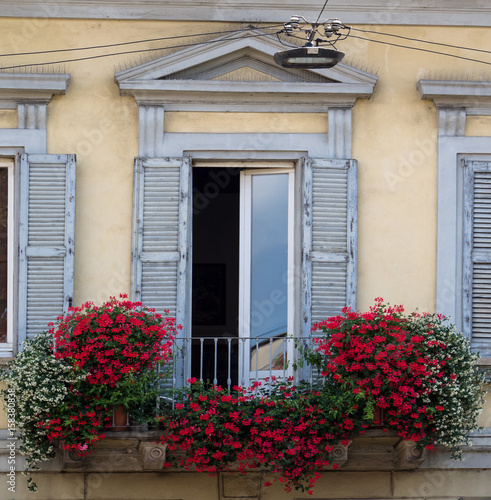 Balcony decorated with white and red flowers © gpriccardi