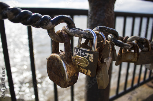 Rusty padlocks on a railing at Liverpool's Albert Dock