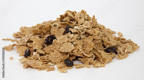 Mound of bran cereal flakes with raisins.