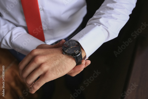 closeup fashion image of luxury watch on wrist of man. body detail of a business man.