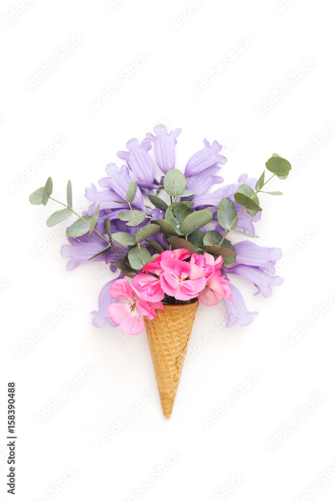 Creative still life . ice cream waffle cone with flowers . Flat lay, top view, copy space