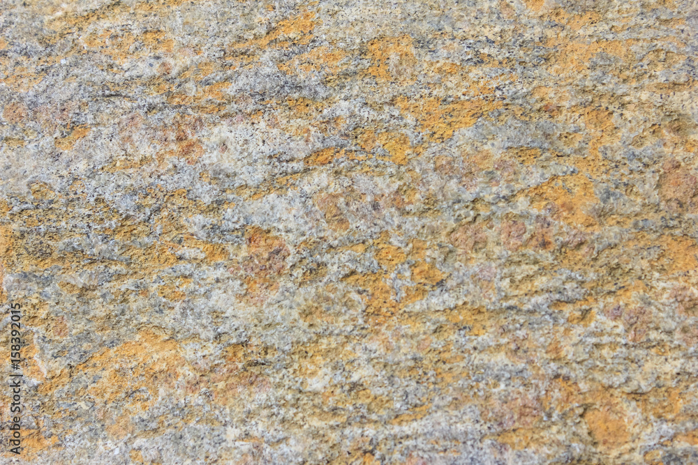 The structure of the stone. rough texture of a large stone boulder. Part of the stone, with a very nice uneven surface..