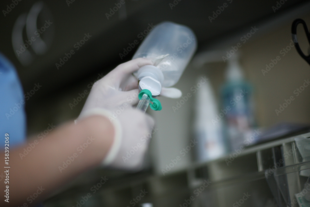 The nurse fills the syringe with a medicine for therapeutic manipulation The nurse fills the syringe with a medicine for therapeutic manipulation