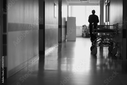 Silhouette of a man in the corridor of the surgical department of the hospital © Anna Jurkovska