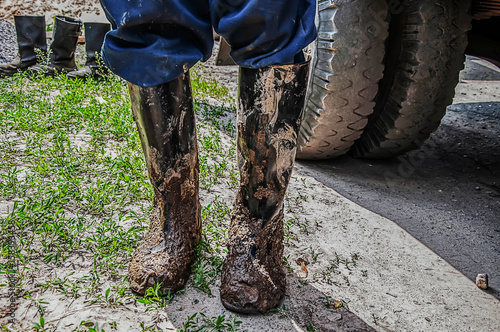 A worker in dirty boots. Background blur.
