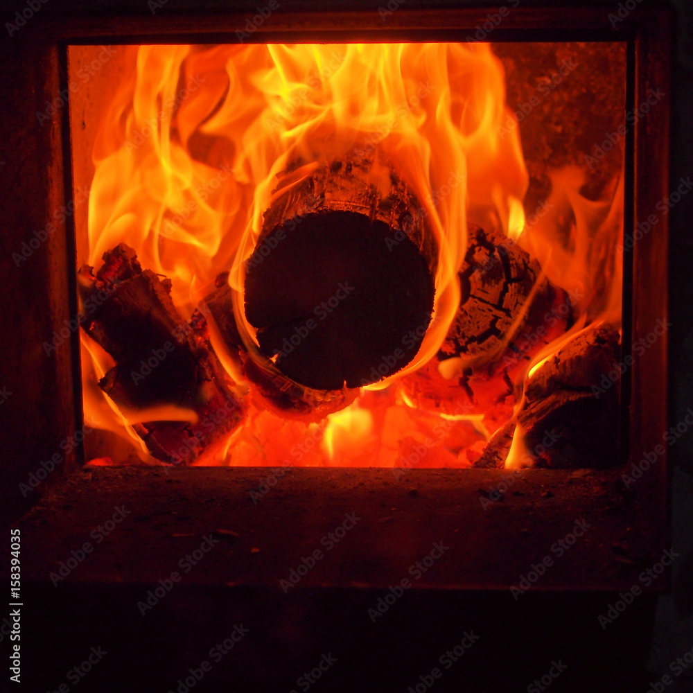 The flames in the firebox. Burning firewood. The firebox of the furnace.  Stock Photo | Adobe Stock