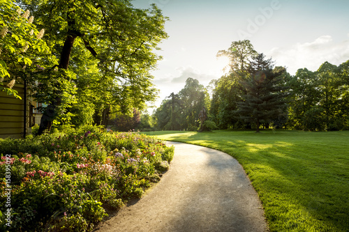 Canvas Print Panorama of city park with footpath and flowers