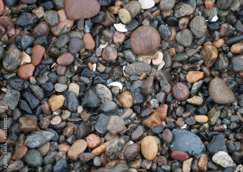 Small wet stones by the ocean Small wet stones by the ocean