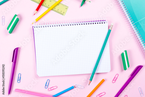 School stationery on pink background with copyspace