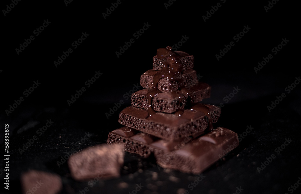 Stack of black pore chocolate on a black background Stack of black pore chocolate on a black background