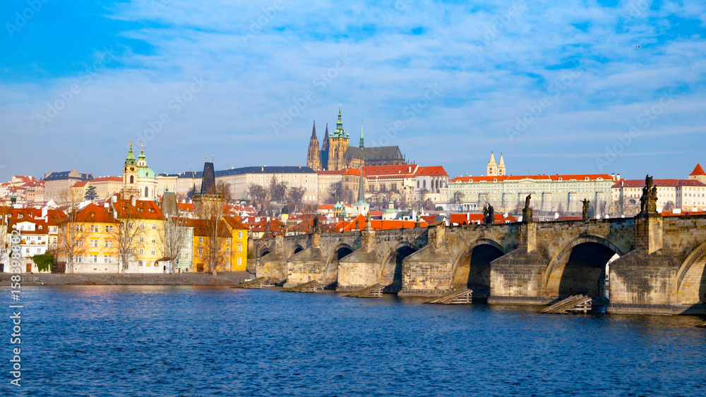 Prague Hradcany Panorama on sunny day. Charles Bridge over Vltava River with Prague Castle, Czech Republic.