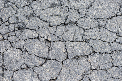 Cracked asphalt on road. Abstract background.