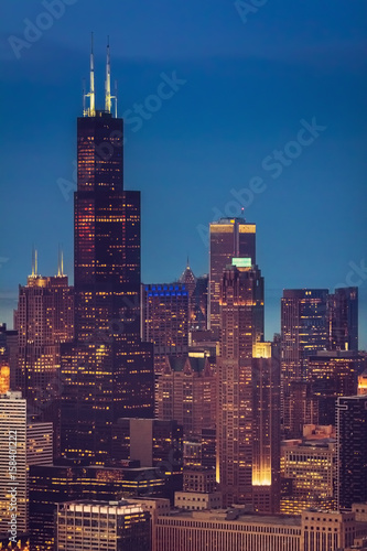 Chicago Downtown skyscrapers at dusk, aerial helicopter view, United States