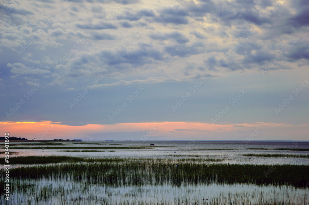 Sunset over the Bay - landscape of the marine in the evening. The nature of the sea in calm. Sunset over the Bay - landscape of the marine in the evening. The nature of the sea in calm.